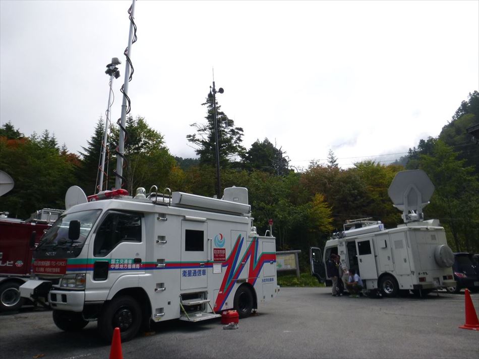 御嶽山の入口に多数のテレビ局の車と混じり設営した衛星通信車